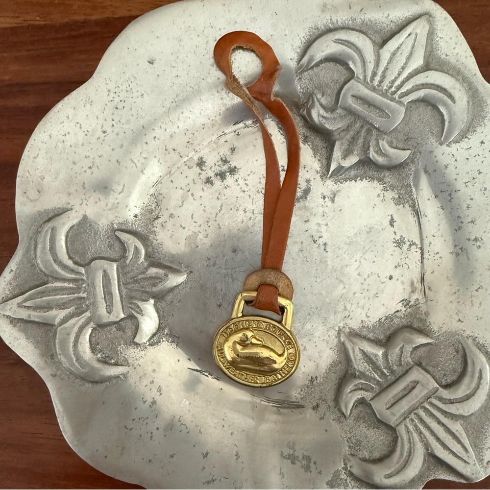 Dooney & Bourke brass  hang tag